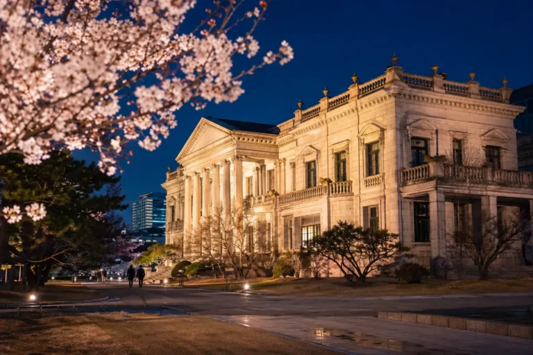 Seokjojeon illuminated at night during a spring evening tour at Deoksugung Palace.