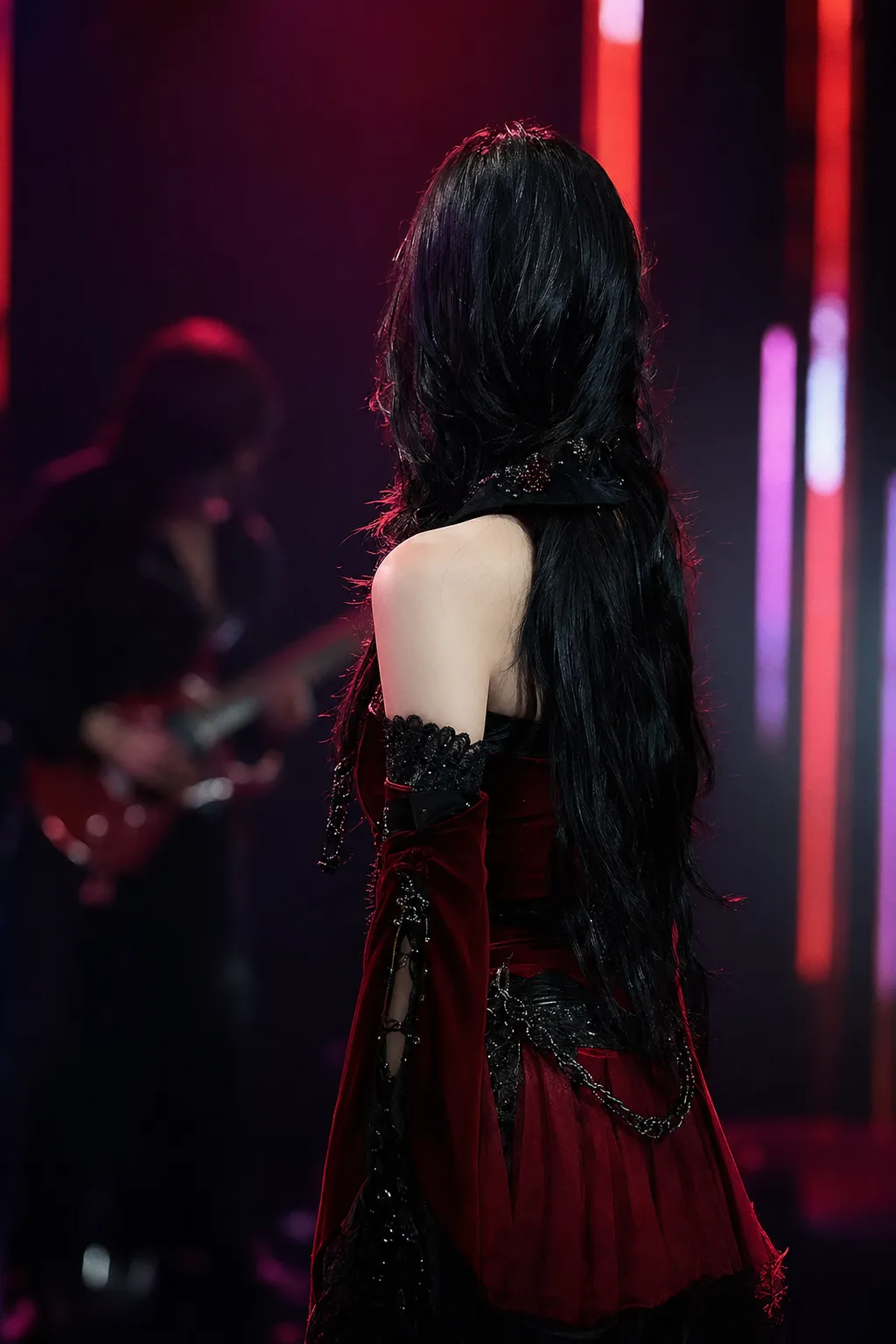 Anonymous K-pop performer and psychedelic rock musician silhouettes under crimson Seoul stage lighting, evoking the Dracula remix chart milestone.