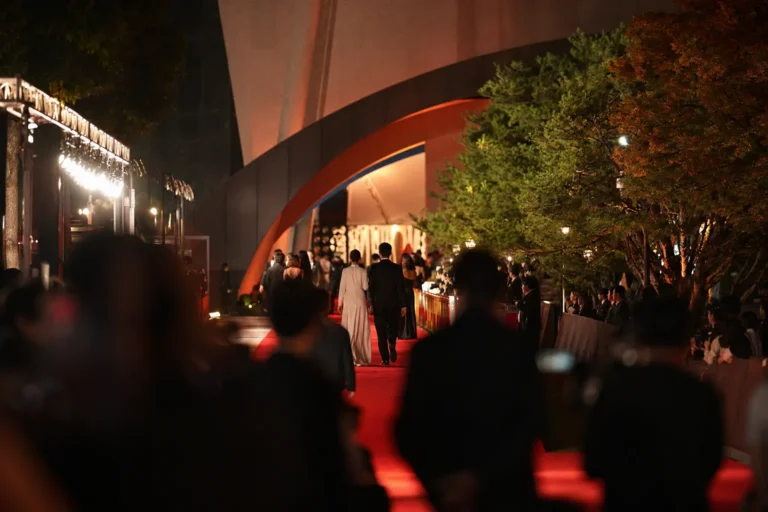 Cinematic opening night scene at a modern South Korean film festival red carpet.
