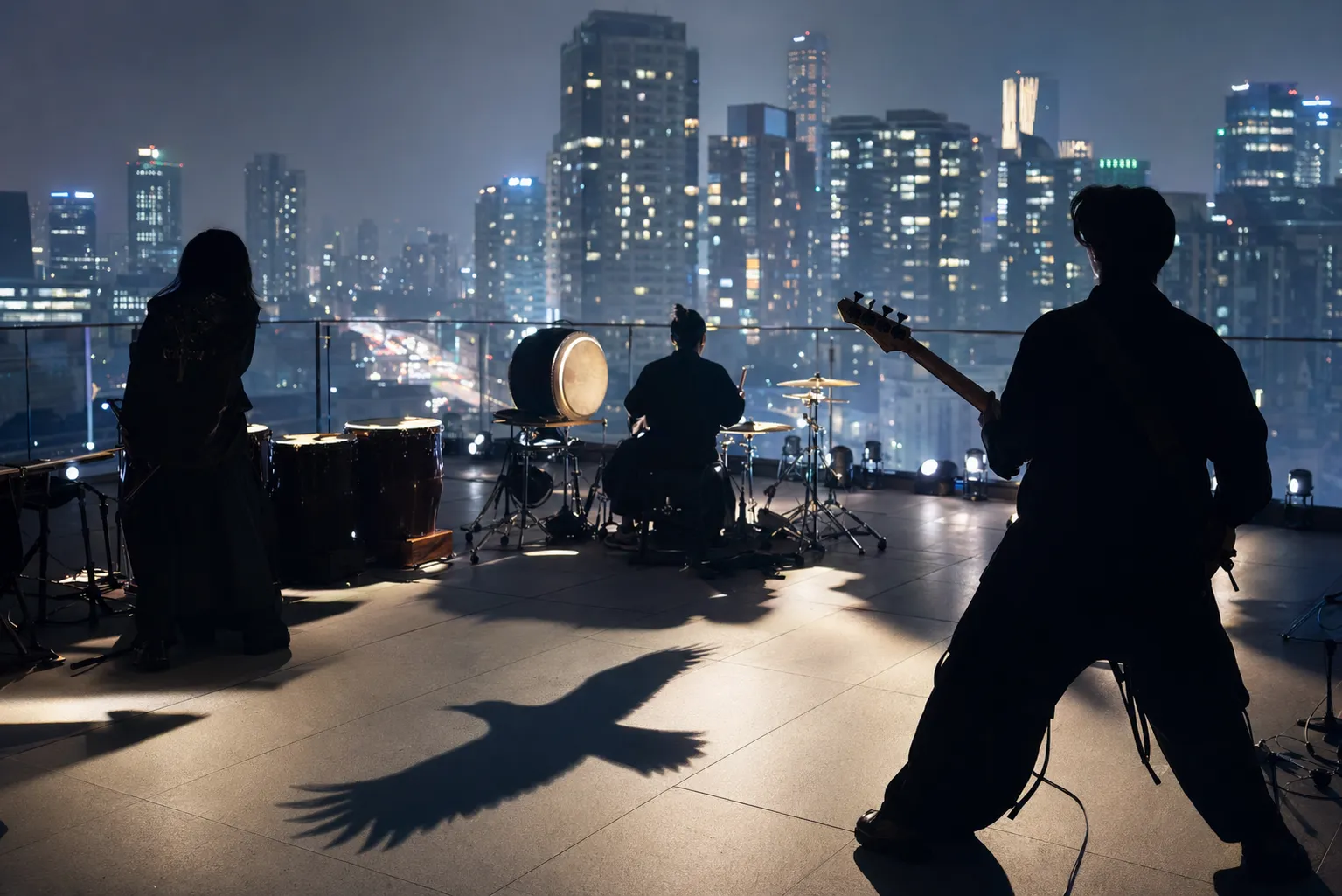 Anonymous musicians on a modern Seoul rooftop stage with Korean instruments and a crow motif, suggesting Leenalchi's global single release.