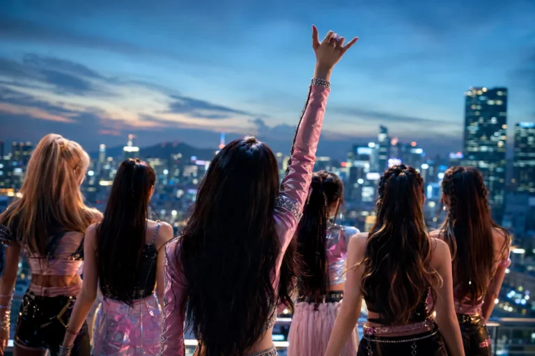 Silhouetted K-pop performers in Seoul with a pinky-up gesture and cinematic lighting.